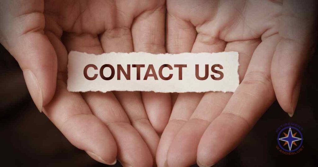 Two open hands holding a piece of paper with the words 'Contact Us' written in bold. The Retirement Wanderlust logo is visible in the bottom right corner, featuring a compass design symbolizing travel and exploration."